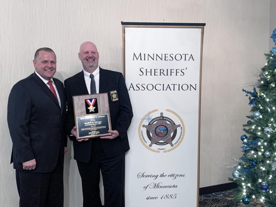Renville County Sheriff Scott Hable (left) awards Evan Verbrugge with the President’s Award for his contributions to the Minnesota Sheriff’s Association Dec. 10 at the annual winter convention in Alexandria. Verbrugge has 33 years in law enforcement and has been Rock County sheriff since 2007. Submitted Photo
