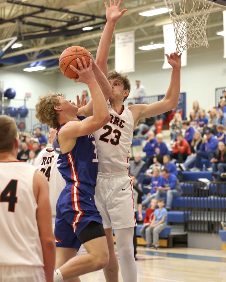 Patriot senior Riley Tatge goes up against a Red Rock Central defender at home Friday, Dec. 15. H-BC beat the Falcons 78-50.
