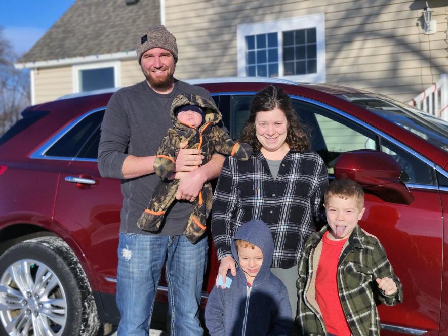 The Tyler and Miranda Goodchild family won the 2017 Cadillac XT5 in a raffle at Bethlehem Lutheran Church in Hills. The Goodchilds of rural Lester, Iowa, purchased the ticket hours before the Nov. 17 drawing from neighbor Randy Warner, whose parents donated the car to the church. Photo courtesy of Randy Warner