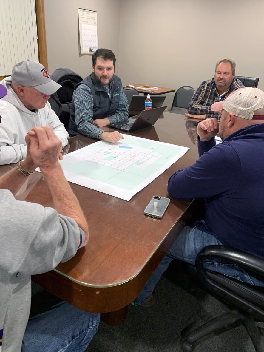 Chris Webb (center) from the Southwest Regional Development Commission talks with Hills City Council members (clockwise) Mayor Keith Elbers, Vickie Busswitz (not pictured), Cory Metzger, Alan Leenderts and Ross Metzger about mapping various property designations before adopting the city’s first formal zoning ordinance. Mavis Fodness/Rock County Star Herald Photo
