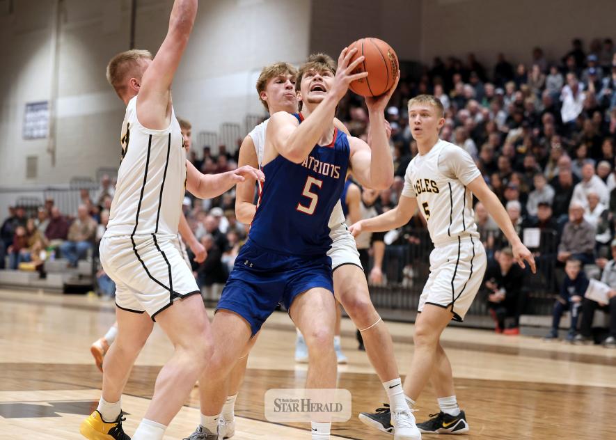 Greg Hoogeveen photo/HBCBBB1 Hills-Beaver Creek Patriot  senior Jamin Metzger looks to the rim covered by two Southwest Minnesota Christian players in Section 3A sub-section semifinal action Saturday, March 7, in Marshall. The Patriots beat the Eagles 69-48 in the contest to play for section championship.