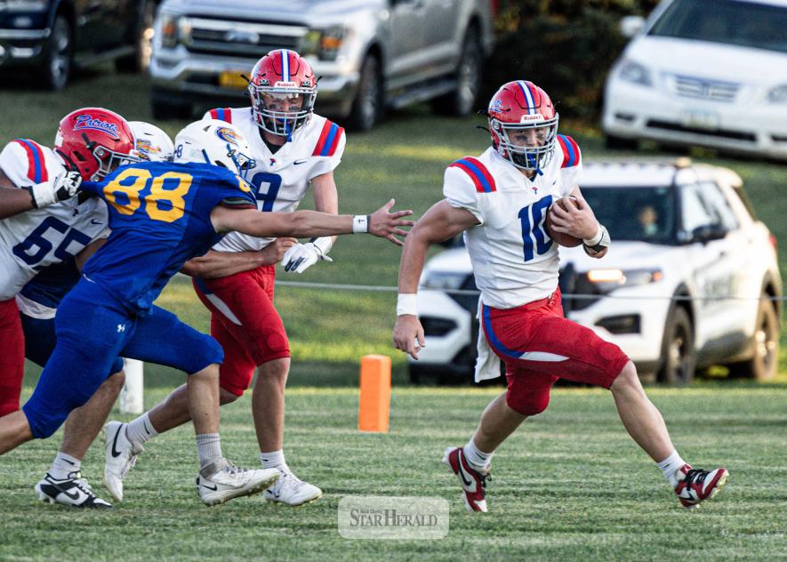 Samantha McGaffee photo/0910 HBC/AEfootball1 H-BC junior Brodie Metzger, No. 10,  finds an edge against the Dragons. Adrain-Ellsworth junior Cael Schettler , No. 88, reaches to try and grab Metzger on the play.