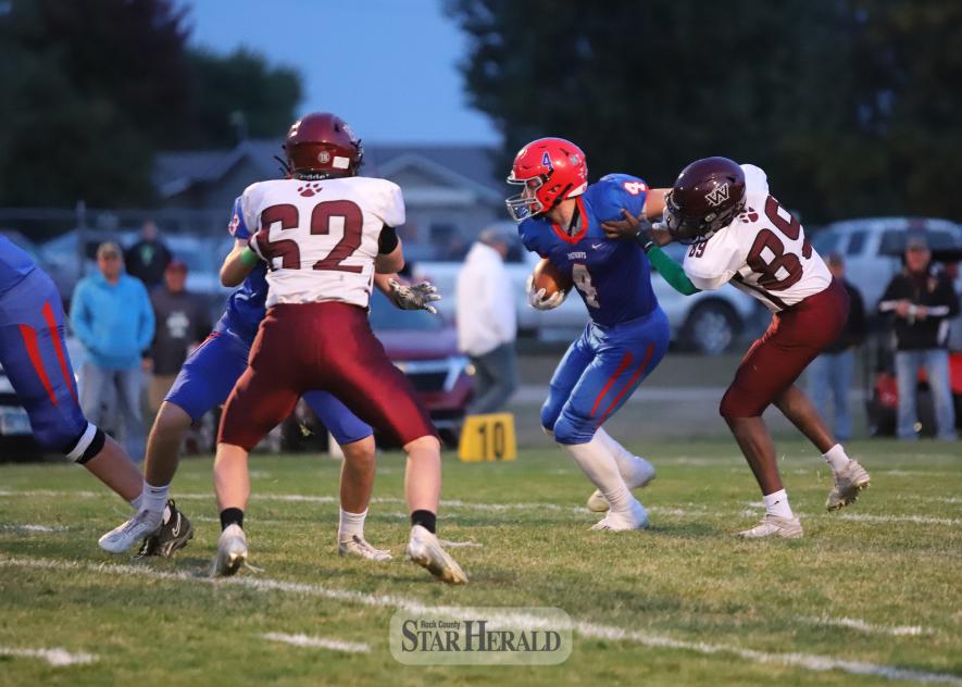 H-BC senior running back Beau Bakken stiff-arms a Mountain Lake defender to gain valuable yards against the Wolverines Friday, Oct. 11, at home. The Patriots won the contest 20-8 and remain undefeated for the season.