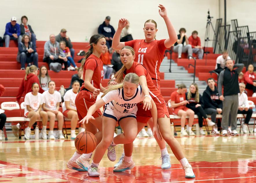 Greg Hoogeveen photo/LHS GBB1 LHS senior Jenna Bullerman (center), senior Ella Schmuck (left), and sophomore Taya Johnson fight for position during the Dec. 9 home game against Jackson. Luverne held off the Huskies winning the game 74-71.