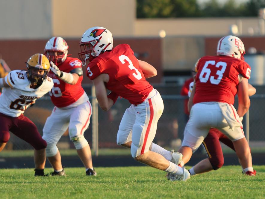 Junior Jaydon Johnson runs past his teammates blocking the way against Jordan Friday, Sept. 6. Blocking are seniors Ryker Johnson, No. 56, and Layne Sasker, No. 63. 
