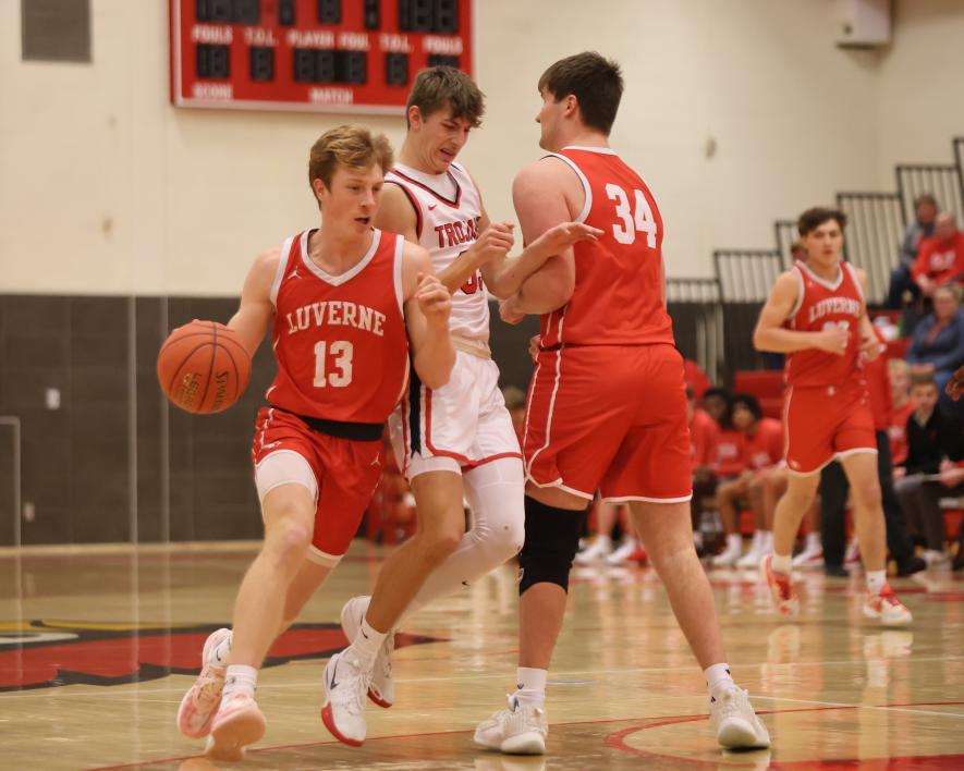 LHS junior Jaydon Johnson, No. 13, works around a block set by his teammate senior Eli Woodley, No. 34, against Worthington. The Cardinals hosted Worthington Thursday, Feb. 13, beating the Trojans 91-73. Greg Hoogeveen/Rock County Star Herald Photo