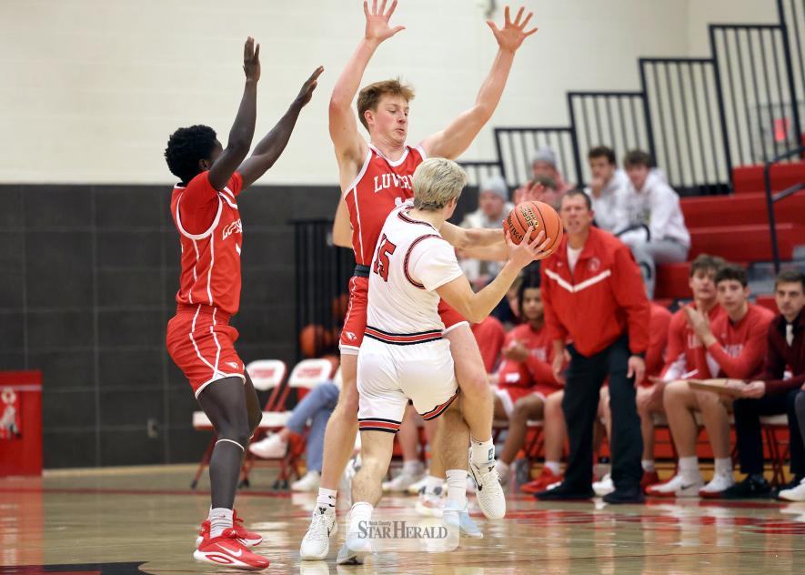 Greg Hoogeveen photo/LHSBBB2 LHS junior Darius Dolo, left, and senior Jaydon Johnson set a block as Redwood Valley tries to move the ball past mid court Dec. 19. LHS beat Redwood Valley 74-43 in the game.