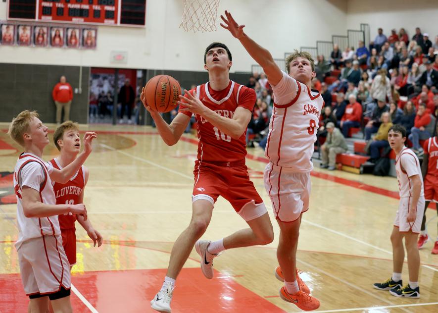 Greg Hoogeveen photo/LHSBBB3 LHS junior Coy Thone switches hands in midair for a basket against St. James Jan. 9. Luverne beat the Saints 56-53.