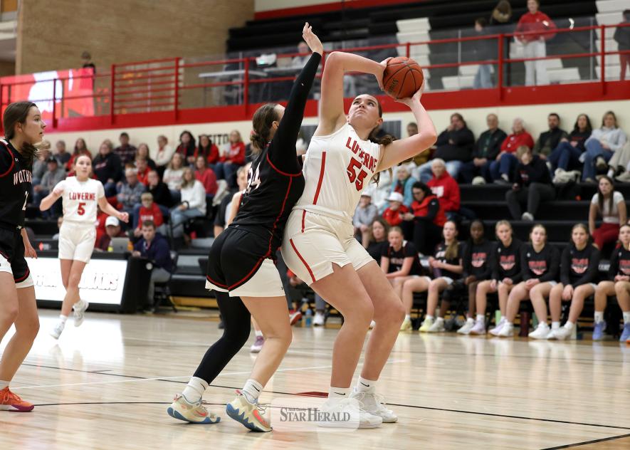 Greg Hoogeveen photo/LHSGBB1 LHS freshman Gracyn Woodley protects the ball under the hoop against Worthington Friday, Jan. 2, on the road. The Luverne girls beat the Trojans 74-28 in the game.
