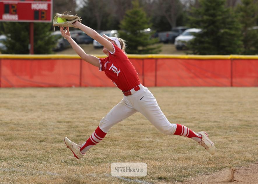 Greg Hoogeveen photo/LHSSB1 Luverne senior Allie Kracht snags the softball for an out before it goes foul against Adrian-Ellsworth Monday, March 30, in Luverne. The Cardinals beat the Dragons 15-5 in the game.