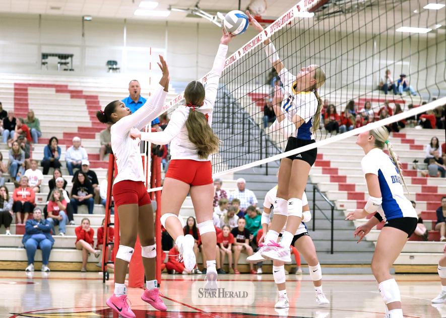 Greg Hoogeveen photo/LHSAE1 LHS sophomore Emma Cowell jumps to lift the ball as A-E sophomore Charlee Hehnhoff follows through with a spike attempt above the net Thursday, Oct. 22, in Luverne. The Dragons beat LHS 3-0 in the Cardinals final match of the regular season.