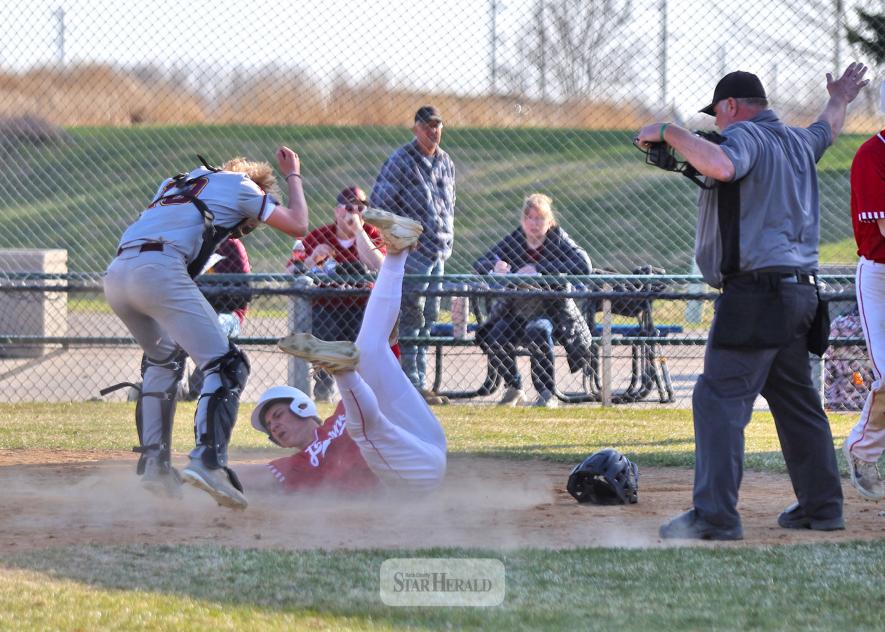 LHS senior Landon Ahrendt safely touches home plate after avoiding a tag at home April 11, at Redbird Field. Luverne beat Blue Earth 12-2 in the first game of their doubleheader.