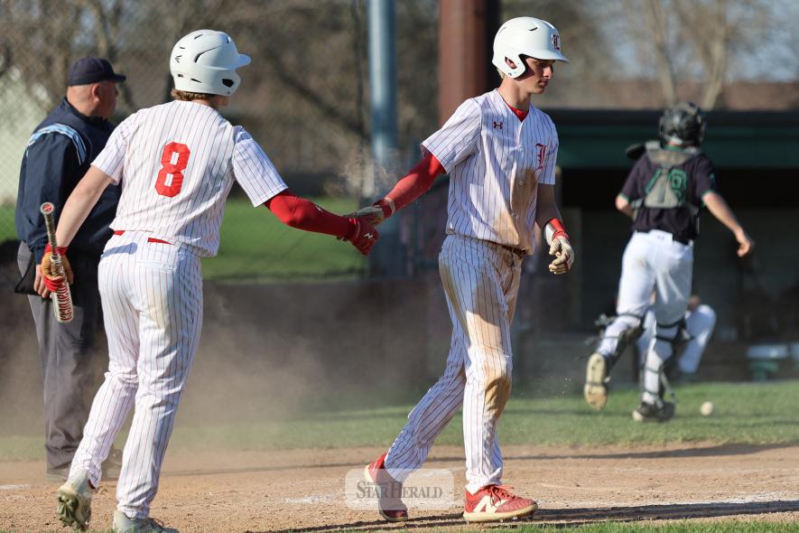Cardinals Landyn Lais, No. 8, and Jaxon Lais slap hands after Jaxon slid into home against Pipestone Tuesday, April 29, on the road. Luverne beat the Arrows 12-7.