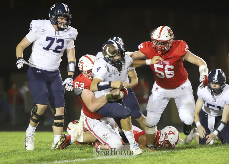 LHS senior Layne Sasker, No. 63, tackles a Jackson running back after he loses the ball during a play. Senior Ryker Johnson, No. 56, tries to push his way to the ball as it comes out Thursday, Oct. 10, in Luverne. LHS fell 38-0 in the contest.
