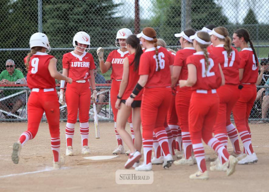 Senior Payton Behr, No. 9, strides home and is greeted by her teammates after hitting a home run against Edgerton at home. LHS lost the game 11-1.