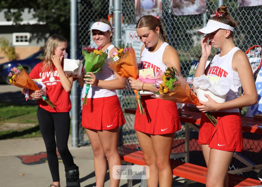 Greg Hoogeveen photo/1008LHStennis1 LHS tennis team celebrates senior night Oct. 1 in Luverne. Seniors Marlee Nelson-manager, left, Allyssa Evers, Olivia Ver Steeg and Sophia Remme receive flowers before the match with Marshall. LHS fell 6-1 to the Tigers.