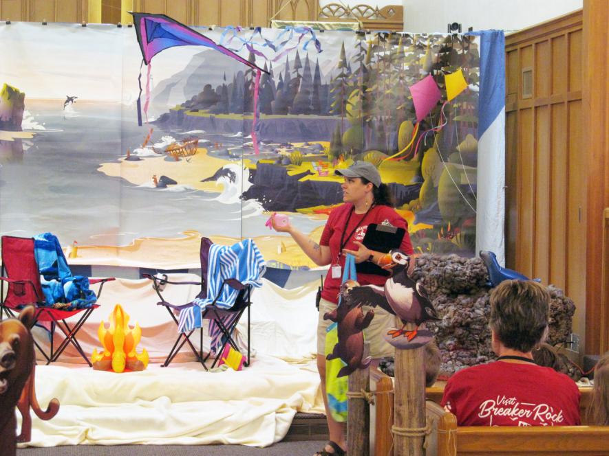 Jessica Blocker, director of Christian education at St. John, opens the first night of VBS. Shared Image