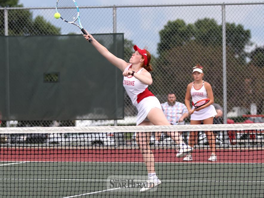 Junior Hannah Kempema stretches for the ball as her partner junior Elizabath Mulder watches. Kempema and Mulder fell 6-3, 7-5 to St. James in the match Thursday, Aug. 29.
