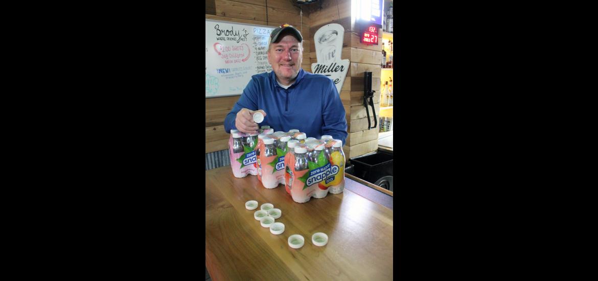 Deon Carriere holds a Snapple bottle cap with a Real Fact printed inside. He uses the Real Facts for Tuesday Trivia questions at his business, Brody’s Bar in Hills. Carriere created the evening event to honor his enjoyment of Snapple and trivia while fundraising for the Leukemia and Lymphoma Society. Mavis Fodness/Rock County Star Herald Photo