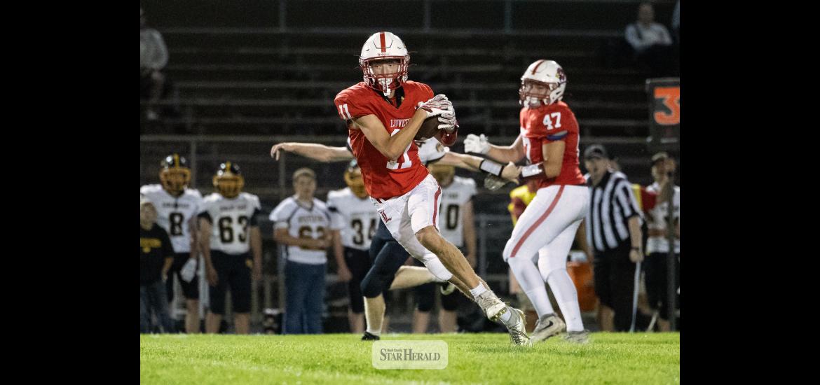 Greg Hoogeveen photo/0917LHSFB1 Cardinals junior Jaxon Pick, No. 11, looks for defenders after making a catch in the middle of the field. Pick took the ball to the house. Luverne beat Sibley East 55-6 at home.