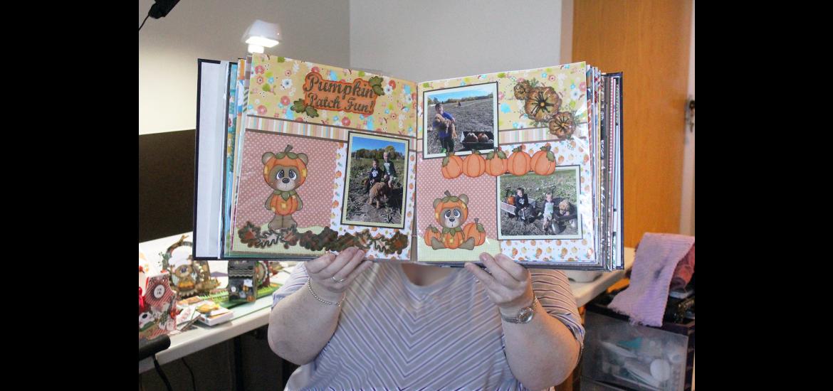 Connie Kafka of Luverne holds a scrapbook album that she is creating for a friend. She shares her "Prairie Paper Crafts" designs on Facebook, but she doesn't sell them, preferring to give them away. Mavis Fodness/Rock County Star Herald Photo