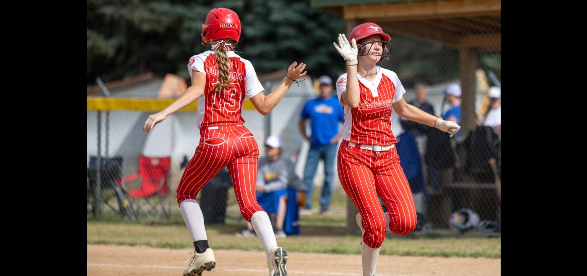 12U players Molly Hoogendoorn,  No. 13, and Avery Van’t Hof slap hands switching spots on the field June 26.