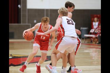 LHS sophomore Jaydon Johnson dribbles around a screen set by teammate junior Landon Ahrendt Tuesday, Jan. 9, in Luverne. The Cardinals fell to Worthington 71-68 in a close contest.