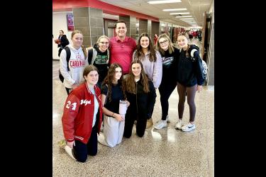 School resource officer Jeff Stratton (center) says he likes to spend time in hallways and common areas to connect with students in Rock County. On Monday he caught several students in Luverne to pose for a photo. Pictured are (front, from left) Bridget Thielbar, Khloe Visker, Amira Cowell, Hannah Cowell, Morgan Bonnett, Stratton, Kenedee Franken, Emma Deutsch and Marlee Nelson. Lori Sorenson/Rock County Star Herald Photo