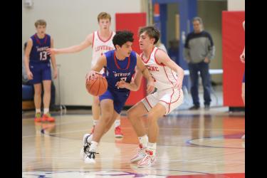 Luverne and Hills-Beaver Creek go head-to-head Monday. Feb. 5, in Hills.H-BC sophomore EJ Wegener, in blue, tries to drive past LHS junior Carter Sehr in the game. The Cardinals beat the Patriots 63-59 in a tight physical game.