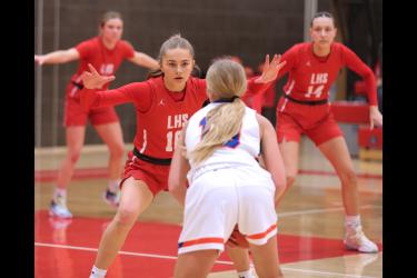 Senior Sarah Stegenga (No. 10) guards her Canby player as fellow seniors Kiesli Smith (No. 14) and Tori Serie (No. 5) watch for a pass in their final home game Tuesday, Feb. 20, in Luverne. The Cardinals beat Canby 69-30 on Parents Night.