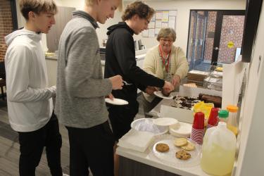 Brenda Teal (far right) shares a piece of her chocolate retirement cake with Luverne Student Council representatives (from left) Carter Sehr, Zach Overgaard and Patrick Kroski Thursday afternoon, Feb. 29. The students presented Teal a card in honor of her retirement from the district office after 32 years. Mavis Fodness/Rock County Star Herald Photo