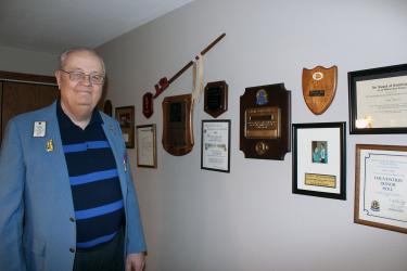 Dick Herman of Luverne stands next to some of the awards he earned as a member of the Lions Club International. Herman recently received a 50-year pin for his perfect attendance in the Lions. Mavis Fodness/Rock County Star Herald Photo
