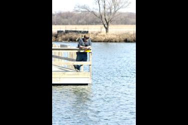 Bryce Schomacker of Luverne enjoys fishing from the dock into open water Monday afternoon at Schoeneman Park south of Luverne. Typically, anglers are considering taking their ice huts off area lakes as the spring thaw comes near. Mavis Fodness/Rock County Star Herald Photo