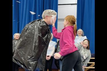 Charlie Wilsey plants a Reddi-wip pie in the face of Jackson Gacke Friday morning in the Hills-Beaver Creek Elementary gym. Lori Sorenson/Rock County Star Herald Photo