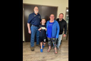 Pictured are Lions Club member Gordon Mulder (left) and Nick, Janelle and Jason Lenz. Submitted Photo