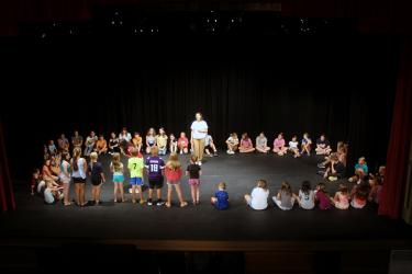 Missoula Children’s Theatre instructor Hannah Luther (center) sings “Row, Row, Row Your Boat” Monday morning as her fellow instructor, Gillian Brown, listens to participants as they cast the 60 participants for Friday’s production of “Robin Hood” at the Palace Theatre in Luverne. Mavis Fodness/Rock County Star Herald Photo