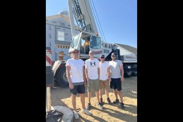Five Luverne High School graduates (from left) Dalton Jacobsma, Joe Guy, Matthew Sterrett, Jake Guy and Brian Barnhart (in crane) came together last week to set the framing and trusses for a home being built for Angela and TJ Newgard (a Luverne teacher). Submitted Photo