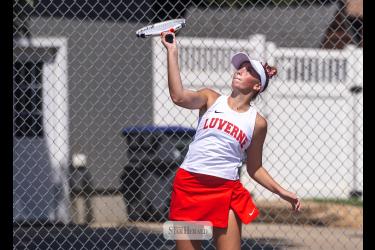 Cardinal senior Sophia Remme sends a serve over the net against Lac Qui Parle in the No. 1 singles match.