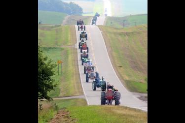 Dozens of tractors motor through and past the Bakken livestock feedlot Friday morning. Lori Sorenson/Rock County Star Herald Photo