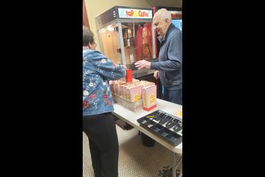 Blue Mound Area Theatre volunteers Karen Buss (left) and Charlie Berzins make and box up popcorn at a recent event at the Palace Theatre. BMAT volunteers served 12,159 people in 2022, according to a recent volunteer report. Contributed Photo