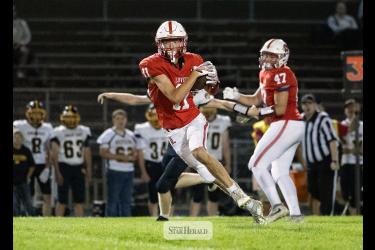 Greg Hoogeveen photo/0917LHSFB1 Cardinals junior Jaxon Pick, No. 11, looks for defenders after making a catch in the middle of the field. Pick took the ball to the house. Luverne beat Sibley East 55-6 at home.