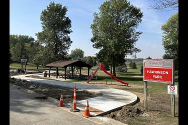 A 10-foot-wide concrete sidewalk goes through Hawkinson Park between Cottage Grove Avenue and the Loop Trail.