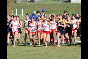 The LHS girls’ 5,000-meter runners take off in Adrian Tuesday, Oct. 10. The Cardinals took the top three finishes in the race. Senior Jenna DeBates was first, seventh-grader Summer Mollberg finished second, and sophomore Ella Schmuck took third place.