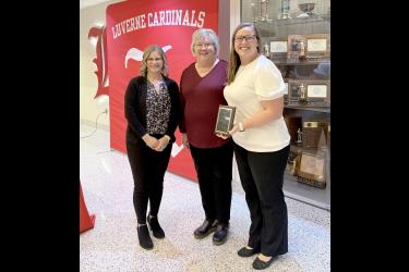 The Luverne Music Boosters Club was named the 2026 LEA Friend of Education during an American Education Week celebration Monday afternoon in the Luverne Middle School-High School Commons. Seana Graber (center) introduced the honorees, past president Heather Johnson (left) and current Music Boosters president Nicole Woodley. Lori Sorenson/Rock County Star Herald Photo