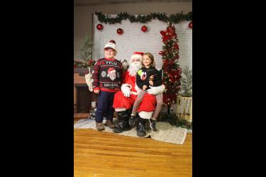 Striking a happy pose with Santa are Remington (left) and Talia Seachris. Mavis Fodness/Rock County Star Herald Photo