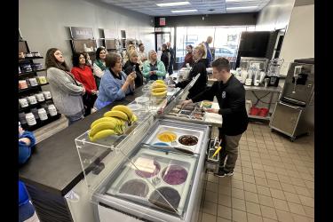 Tyler de Cesare serves up a frozen smoothie bowl during Wednesday’s open house at Functional Nutrition. Lori Sorenson/Rock County Star Herald Photo