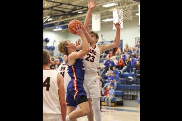 Patriot senior Riley Tatge goes up against a Red Rock Central defender at home Friday, Dec. 15. H-BC beat the Falcons 78-50.