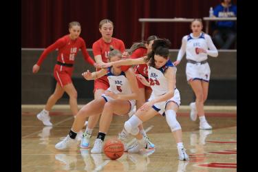 Greg Hoogeveen photos/1228 GBB LHS HBC1 Patriot junior Emma Deelstra, No. 23, and senior Lanae Elbers, No. 5, block out LHS seniors Kiesli Smith, No. 14, and Tori Serie, No. 5, to keep them from grabbing a loose ball Tuesday, Dec. 19, in Luverne. LHS fell 57-51 to H-BC in the game.