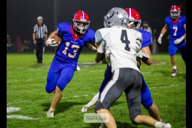 Greg Hoogeveen photo/0924HBCFB1 Patriots junior Max Sammons follows a block by his teammate against Heron Lake-Okabena-Fulda Friday, Sept. 18, in Hills. H-BC won the contest 22-0. 