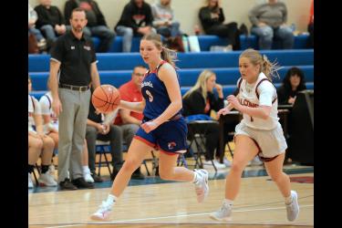 Senior Brynn Rauk dribbles the ball up the court against Red Rock Central Friday, Dec. 1, in Hills. The Hills-Beaver Creek Patriots beat the Falcons 62-15 in their season opener.